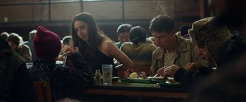 Movie still from “The Kindness of Strangers” (2019), directed by Lone Scherfig – Two people sitting at a table with plates of food in front of them; Medium shot, Over the shoulder angle