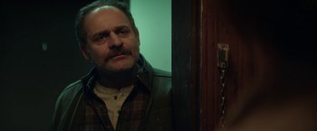 Movie still from “The Kindness of Strangers” (2019), directed by Lone Scherfig – A person standing in front of a door; Close Up shot, Over the shoulder angle