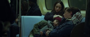 Movie still from “The Kindness of Strangers” (2019), directed by Lone Scherfig – A woman and a child sleeping on a train; Medium shot, High angle