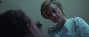 Movie still from “The Kindness of Strangers” (2019), directed by Lone Scherfig – A woman sitting in front of a mirror looking down; Close Up shot, Over the shoulder angle