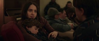 Movie still from “The Kindness of Strangers” (2019), directed by Lone Scherfig – A woman sitting next to a child on a couch; Close Up shot, Over the shoulder angle