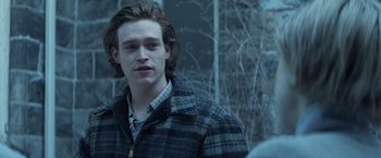 Movie still from “The Kindness of Strangers” (2019), directed by Lone Scherfig – A man in a plaid jacket standing in front of a building; Close Up shot, Over the shoulder angle