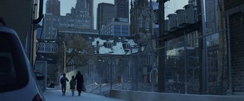 Movie still from “The Kindness of Strangers” (2019), directed by Lone Scherfig – Two women walk down a sidewalk near a church; Extreme Wide shot, High angle