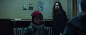 Movie still from “The Kindness of Strangers” (2019), directed by Lone Scherfig – A young boy standing next to a young girl; Medium shot, Low angle