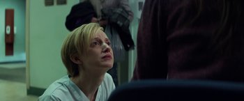 Movie still from “The Kindness of Strangers” (2019), directed by Lone Scherfig – A woman sitting in front of a man in front of a mirror; Close Up shot, Low angle