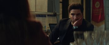 Movie still from “The Kindness of Strangers” (2019), directed by Lone Scherfig – A man sitting at a table in front of a laptop computer; Close Up shot, Over the shoulder angle