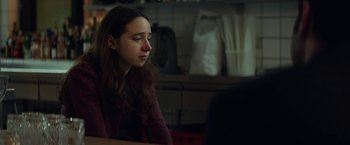 Movie still from “The Kindness of Strangers” (2019), directed by Lone Scherfig – A woman sitting at a table in front of a computer; Close Up shot, Over the shoulder angle