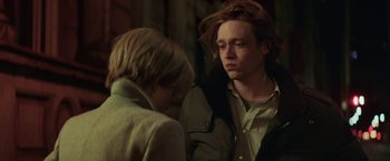 Movie still from “The Kindness of Strangers” (2019), directed by Lone Scherfig – Two people standing next to each other near a wall; Close Up shot, Over the shoulder angle