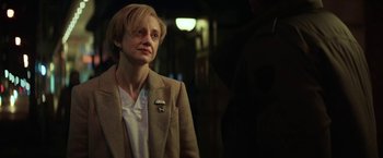 Movie still from “The Kindness of Strangers” (2019), directed by Lone Scherfig – A woman wearing a jacket and a white shirt; Close Up shot, Over the shoulder angle