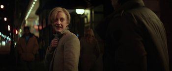 Movie still from “The Kindness of Strangers” (2019), directed by Lone Scherfig – A woman standing in front of a group of other people; Close Up shot, Over the shoulder angle