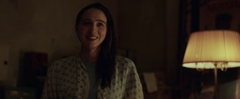 Movie still from “The Kindness of Strangers” (2019), directed by Lone Scherfig – A woman smiling for the camera in a room; Close Up shot, Over the shoulder angle