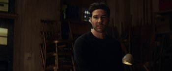 Movie still from “The Kindness of Strangers” (2019), directed by Lone Scherfig – A man in a black shirt is in a room; Medium shot, Over the shoulder angle