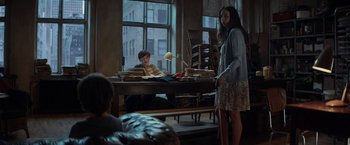 Movie still from “The Kindness of Strangers” (2019), directed by Lone Scherfig – Two people sitting at a table in front of a window; Wide shot, Over the shoulder angle