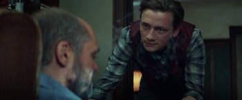 Movie still from “The Kindness of Strangers” (2019), directed by Lone Scherfig – A man looking at himself in the mirror; Close Up shot, Over the shoulder angle
