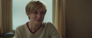 Movie still from “The Kindness of Strangers” (2019), directed by Lone Scherfig – A person with short hair; Close Up shot, Over the shoulder angle