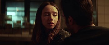 Movie still from “The Kindness of Strangers” (2019), directed by Lone Scherfig – A young woman and a young man in a room; Close Up shot, Over the shoulder angle