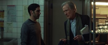 Movie still from “The Kindness of Strangers” (2019), directed by Lone Scherfig – A man and a man talking to each other in front of a mirror; Medium shot, Over the shoulder angle