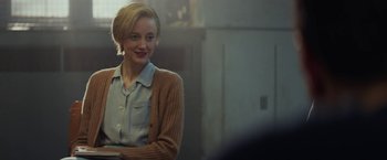 Movie still from “The Kindness of Strangers” (2019), directed by Lone Scherfig – A woman in a brown and blue shirt is smiling; Medium shot, Over the shoulder angle