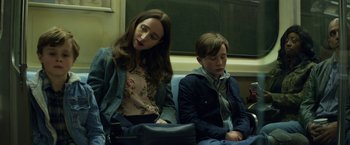 Movie still from “The Kindness of Strangers” (2019), directed by Lone Scherfig – A woman and a young boy sitting on a train; Medium shot, Over the shoulder angle