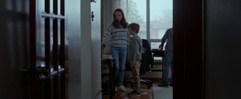 Movie still from “The Kindness of Strangers” (2019), directed by Lone Scherfig – A woman and a boy standing in front of a window; Medium shot, Over the shoulder angle