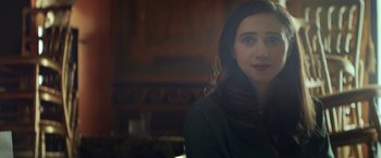 Movie still from “The Kindness of Strangers” (2019), directed by Lone Scherfig – A person sitting in a room; Close Up shot, Over the shoulder angle