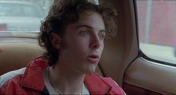 Movie still from “Good Will Hunting” (1997), directed by Gus Van Sant – A young man sitting in the back seat of a car; Close Up shot, Low angle