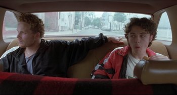 Movie still from “Good Will Hunting” (1997), directed by Gus Van Sant – Two young men sitting in the back seat of a car; Medium shot, Over the shoulder angle