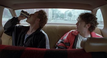 Movie still from “Good Will Hunting” (1997), directed by Gus Van Sant – Two men sitting in the back seat of a car; Medium shot, Low angle