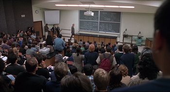 Movie still from “Good Will Hunting” (1997), directed by Gus Van Sant – A group of people sitting in front of a class room; Wide shot, High angle