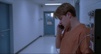 Movie still from “Good Will Hunting” (1997), directed by Gus Van Sant – A man talking on a cell phone in a jail cell; Close Up shot, Low angle
