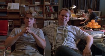 Movie still from “Good Will Hunting” (1997), directed by Gus Van Sant – Two men sitting on a chair in a living room; Medium shot, Over the shoulder angle