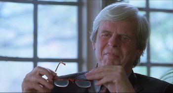 Movie still from “Good Will Hunting” (1997), directed by Gus Van Sant – An older man holding a pair of sunglasses; Close Up shot, Over the shoulder angle