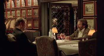 Movie still from “Good Will Hunting” (1997), directed by Gus Van Sant – Two people are sitting at a table with wine glasses; Medium shot, Over the shoulder angle