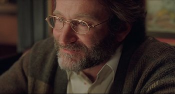 Movie still from “Good Will Hunting” (1997), directed by Gus Van Sant – A person wearing glasses with a beard; Close Up shot, Over the shoulder angle
