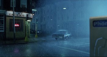 Movie still from “Good Will Hunting” (1997), directed by Gus Van Sant – A car driving down a street in the rain; Extreme Wide shot, High angle