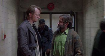 Movie still from “Good Will Hunting” (1997), directed by Gus Van Sant – Two men standing next to each other in a building; Medium shot, Over the shoulder angle