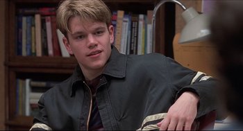 Movie still from “Good Will Hunting” (1997), directed by Gus Van Sant – A man sitting in front of a book shelf; Close Up shot, Over the shoulder angle