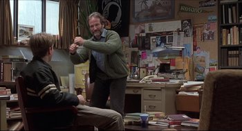 Movie still from “Good Will Hunting” (1997), directed by Gus Van Sant – A man in a room with a bunch of papers on the floor; Medium shot, Over the shoulder angle
