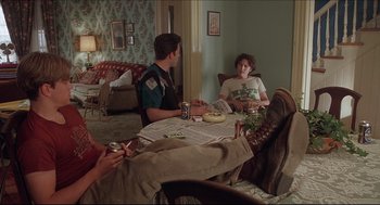 Movie still from “Good Will Hunting” (1997), directed by Gus Van Sant – A group of people sitting around a table eating food; Wide shot, Low angle