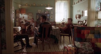 Movie still from “Good Will Hunting” (1997), directed by Gus Van Sant – A group of people sitting around a dining room table; Wide shot, Low angle