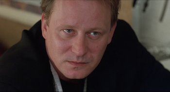 Movie still from “Good Will Hunting” (1997), directed by Gus Van Sant – A person wearing a black shirt; Close Up shot, Low angle