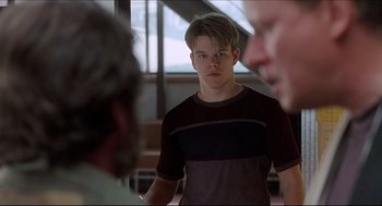 Movie still from “Good Will Hunting” (1997), directed by Gus Van Sant – A man standing in front of two other men; Close Up shot, Over the shoulder angle