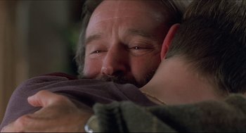 Movie still from “Good Will Hunting” (1997), directed by Gus Van Sant – A person with a beard hugging another person; Close Up shot, Over the shoulder angle