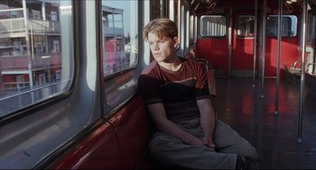 Movie still from “Good Will Hunting” (1997), directed by Gus Van Sant – A man sitting on a train looking out of the window; Medium shot, Low angle