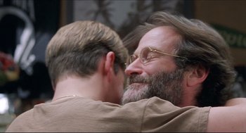 Movie still from “Good Will Hunting” (1997), directed by Gus Van Sant – Two men embracing each other in front of a wall; Close Up shot, Over the shoulder angle