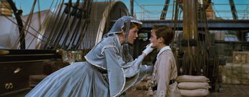 Movie still from “The King and I” (1956), directed by Walter Lang – A man and a woman dressed in period clothing; Medium shot, Over the shoulder angle