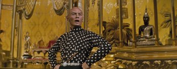 Movie still from “The King and I” (1956), directed by Walter Lang – A wax statue of a man in a black outfit with silver studs; Close Up shot, Low angle
