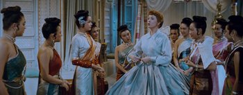 Movie still from “The King and I” (1956), directed by Walter Lang – A group of women standing next to each other in a room; Medium shot, Low angle