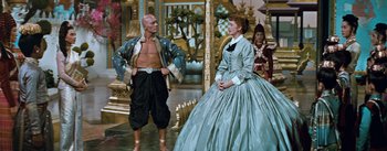 Movie still from “The King and I” (1956), directed by Walter Lang – A man and a woman dressed in medieval clothing; Wide shot, Low angle