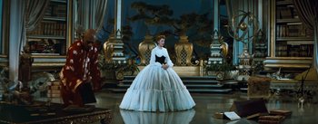 Movie still from “The King and I” (1956), directed by Walter Lang – A woman dressed in a white dress and a black hat; Wide shot, High angle